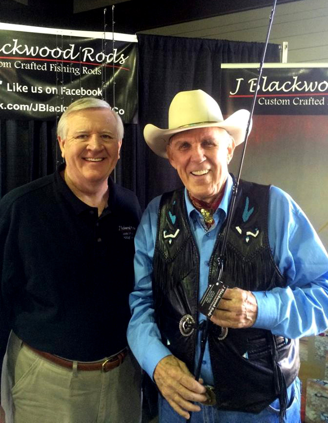 Jerry Standing With Ray Scott Holding Fishing Rods